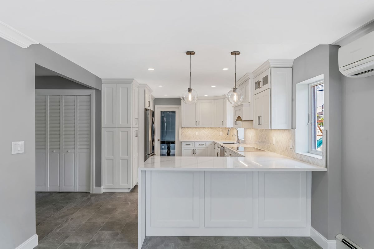 Modern white kitchen renovation by Kuhn Construction in Islip, New York