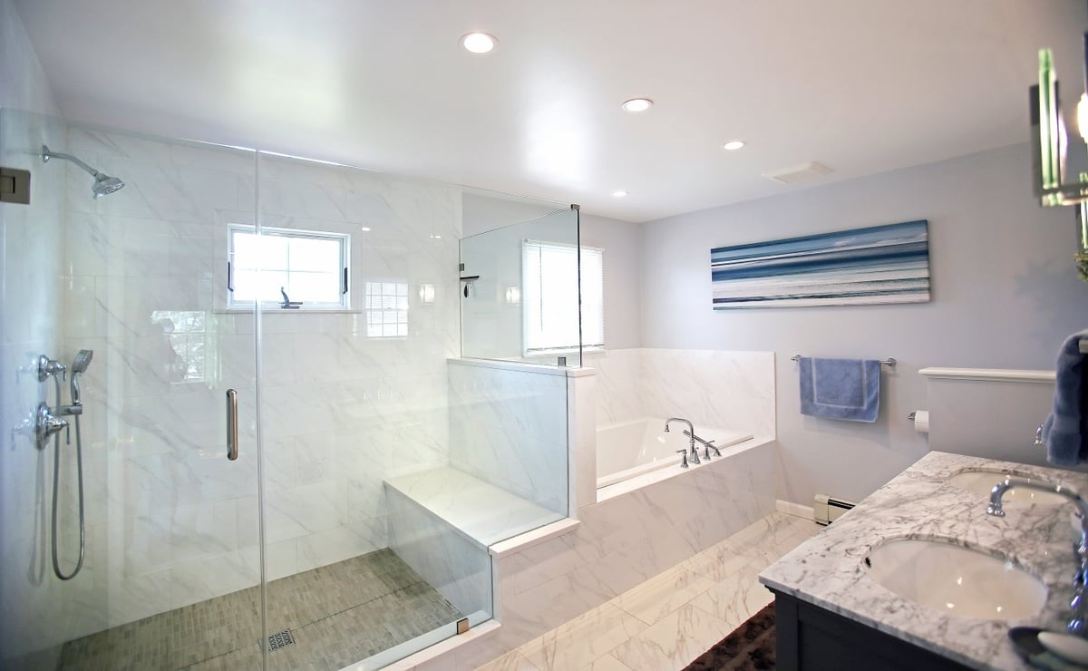 Frameless glass shower with separate soaking tub by Kuhn Construction