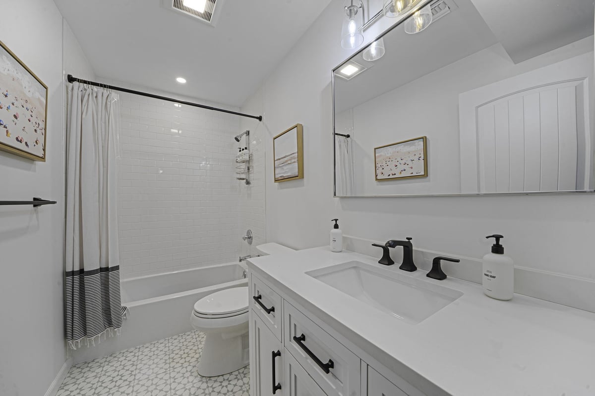 White basement bathroom remodel in Suffolk County, NY by Kuhn Construction