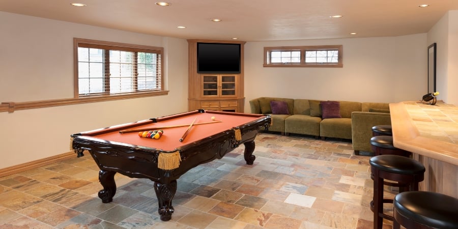 finished basement with pool table and bar